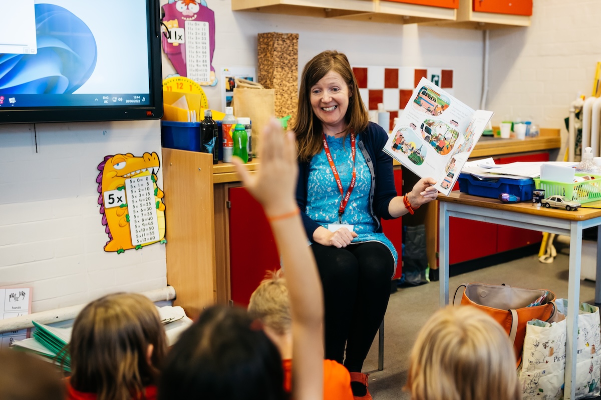 A primary school teacher reads LGBT+ inclusive books for children to the class